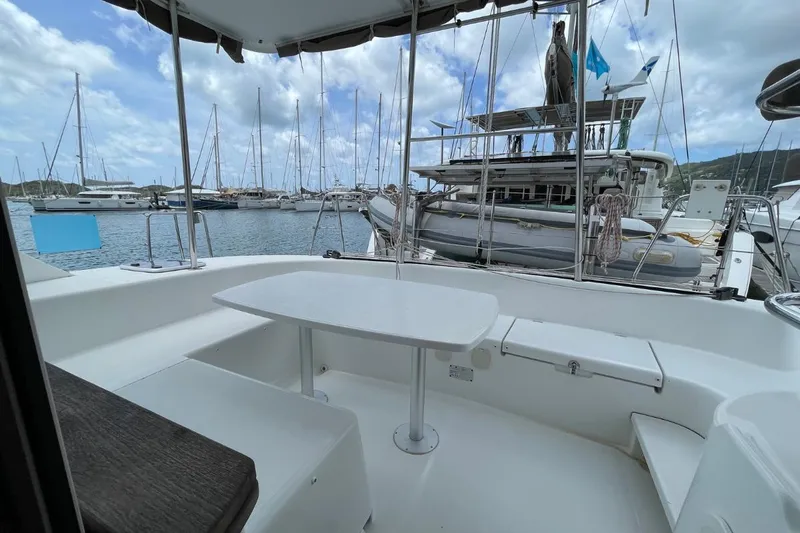 Carnabie Yacht Photos Pics Lagoon 380 S2 catamaran's deck with seating area, docked in a marina, 2014 model.