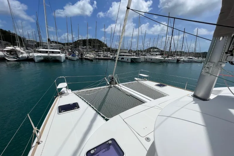 Carnabie Yacht Photos Pics 2014 Lagoon 380 S2 catamaran docked in a marina under a blue sky.