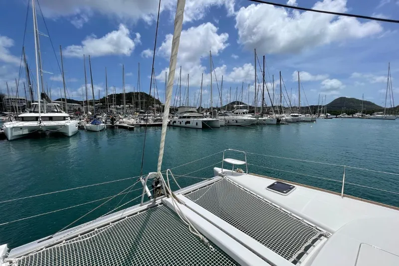 Carnabie Yacht Photos Pics 2014 Lagoon 380 S2 catamaran docked in a marina with clear blue skies.