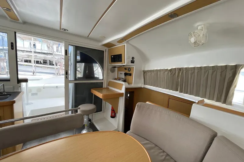 Carnabie Yacht Photos Pics Interior of 2014 Lagoon 380 S2 catamaran, featuring seating, table, and navigation area.