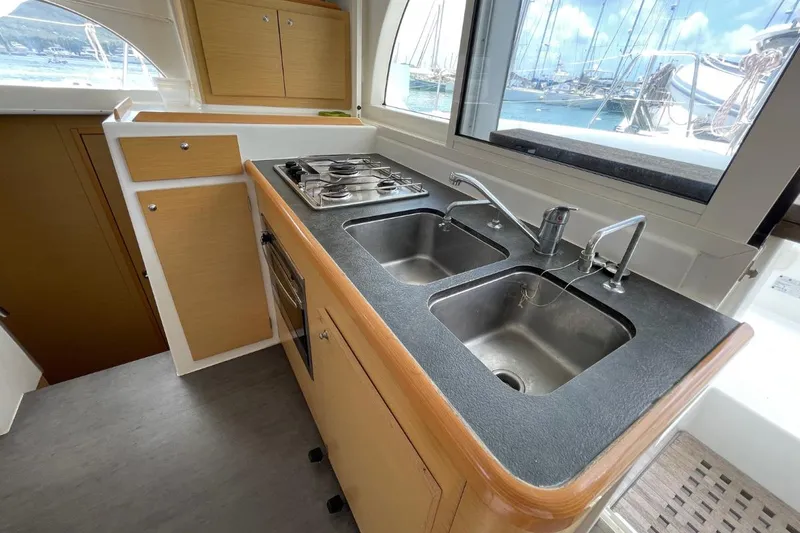 Carnabie Yacht Photos Pics Interior of 2014 Lagoon 380 S2 yacht kitchen with dual sinks and stove.