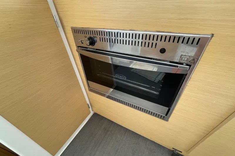 Carnabie Yacht Photos Pics Built-in oven on Lagoon 380 S2 yacht, 2014 model, with wooden paneling.