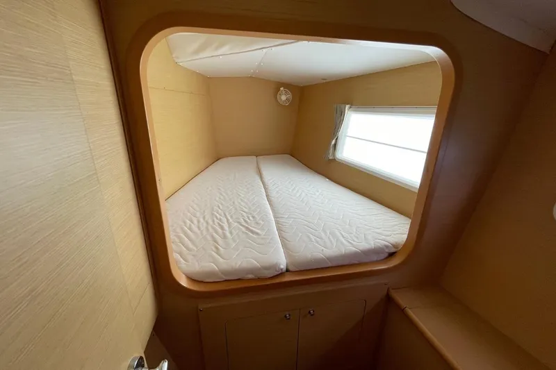 Carnabie Yacht Photos Pics Cozy cabin interior of 2014 Lagoon 380 S2 catamaran with a comfortable bed.