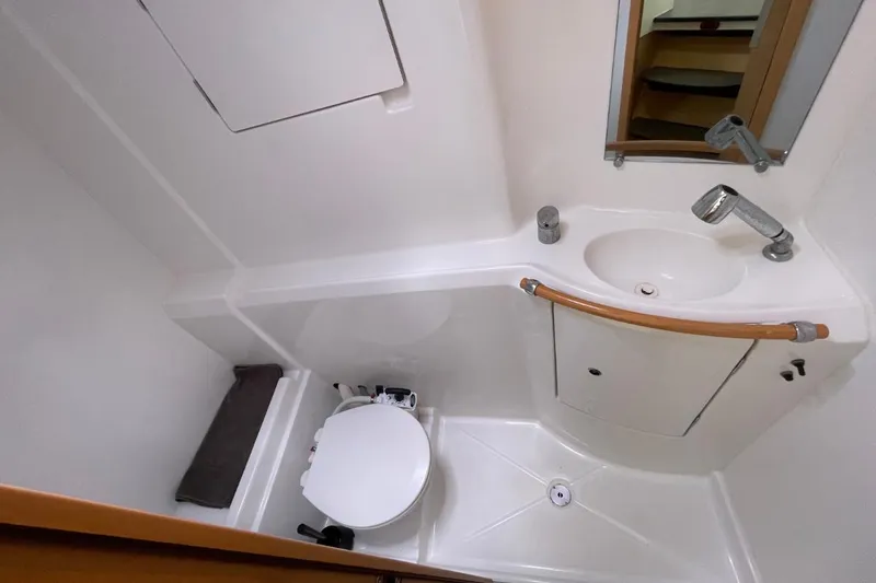 Carnabie Yacht Photos Pics Compact bathroom in 2014 Lagoon 380 S2 yacht with sink, toilet, and mirror.