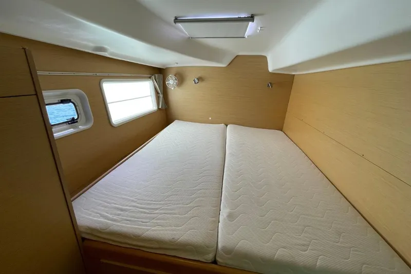 Carnabie Yacht Photos Pics Interior cabin of 2014 Lagoon 380 S2 catamaran with double bed and window view.