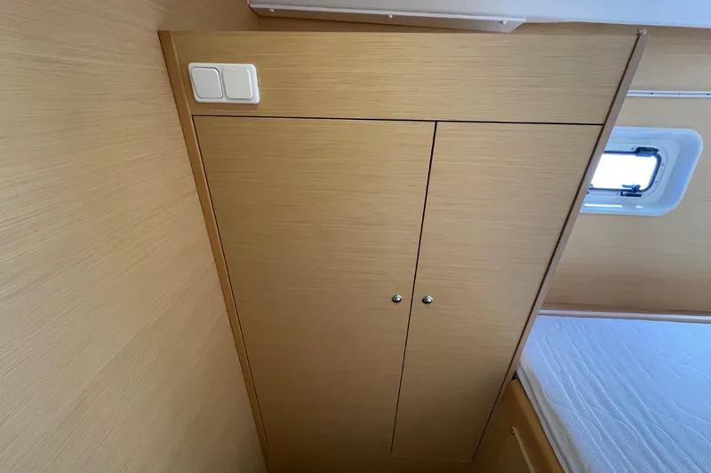 Carnabie Yacht Photos Pics Interior of 2014 Lagoon 380 S2 yacht with wooden cabinetry and a small window.