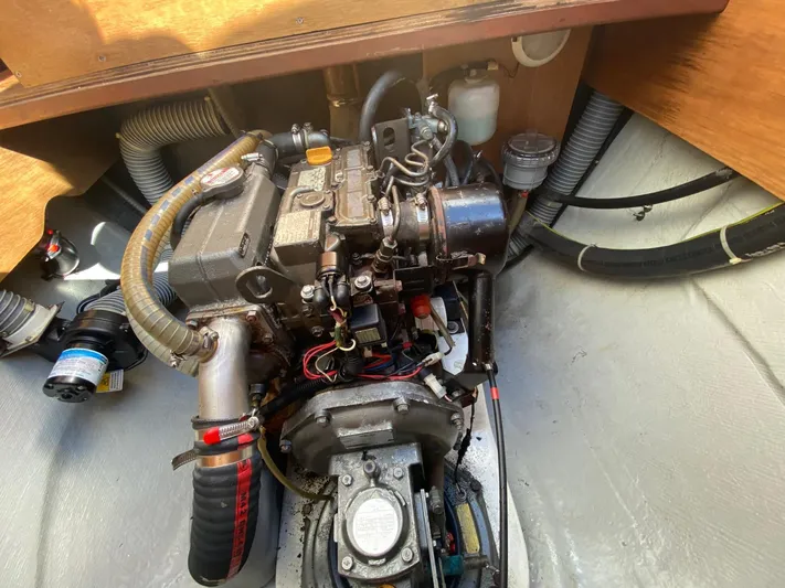 Carnabie Yacht Photos Pics Engine compartment of a 2014 Lagoon 380 S2 catamaran, showcasing mechanical components and hoses.