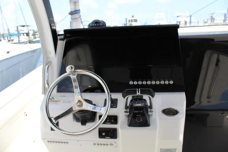  Yacht Photos Pics Helm of 2016 Edgewater 370CC boat with steering wheel and controls.
