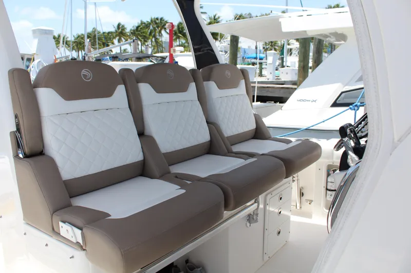  Yacht Photos Pics Luxurious seating on 2016 Edgewater 370CC boat, featuring elegant white and brown upholstery.