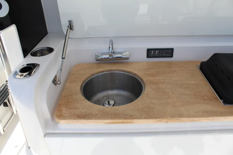  Yacht Photos Pics 2016 Edgewater 370CC boat sink and countertop with faucet and control panel.