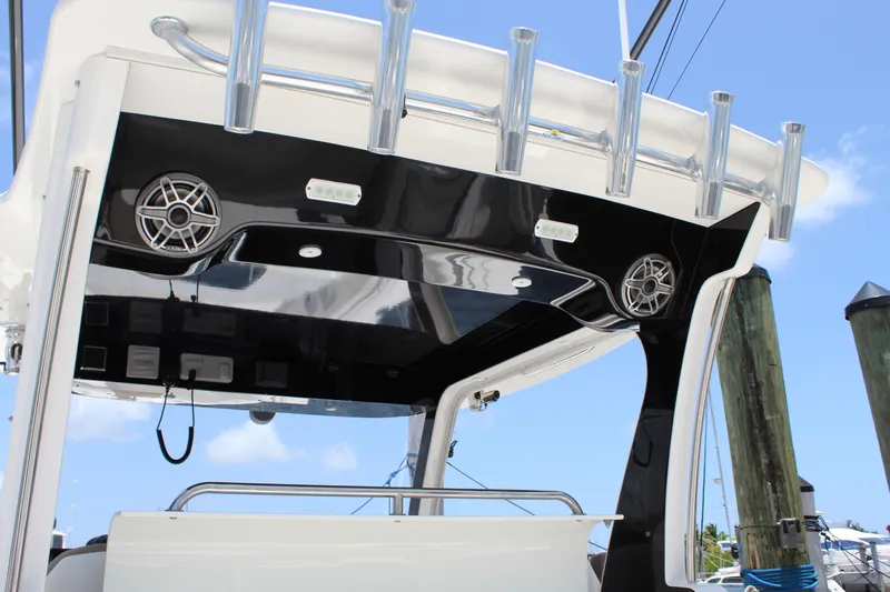  Yacht Photos Pics 2016 Edgewater 370CC boat with sleek black and white design, featuring speakers and rod holders.