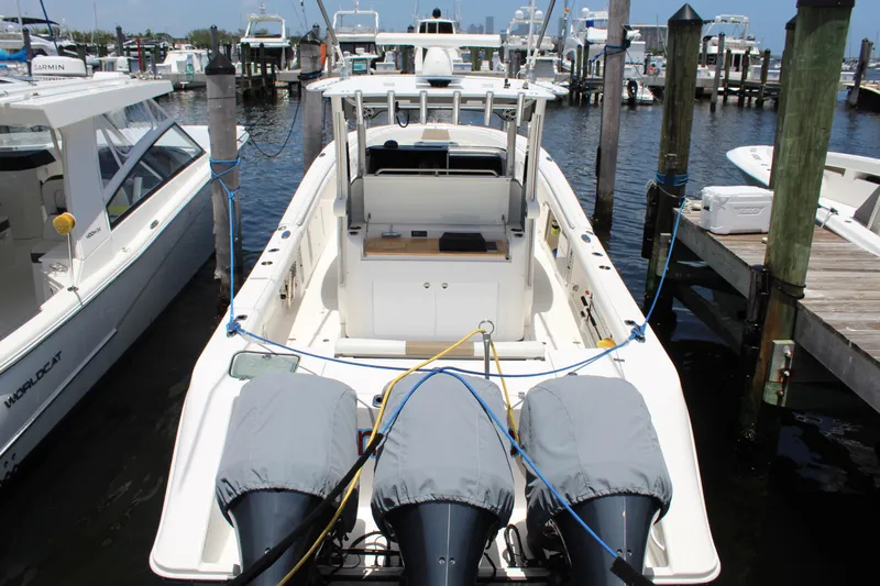  Yacht Photos Pics 2016 Edgewater 370CC boat docked with covered engines, marina background.