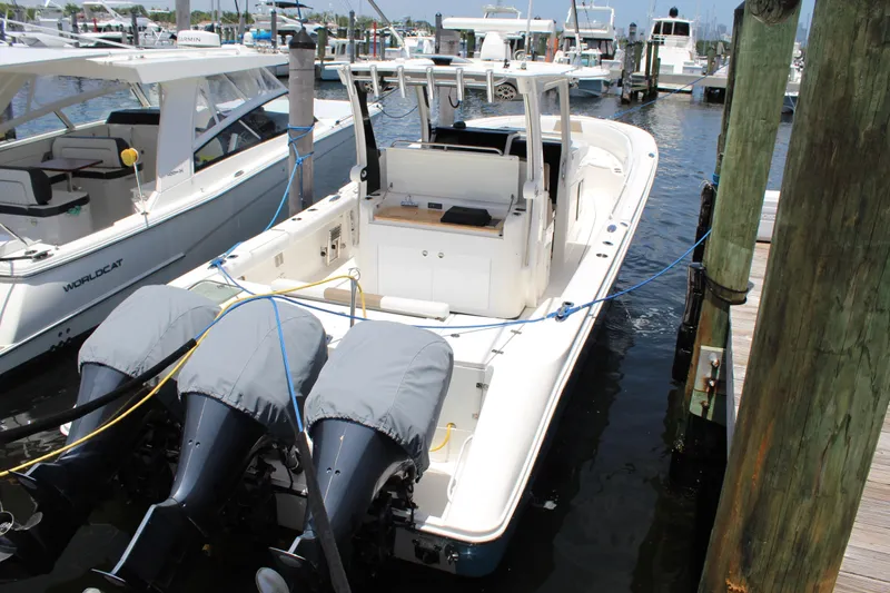  Yacht Photos Pics 2016 Edgewater 370CC boat docked with triple outboard engines, marina background.