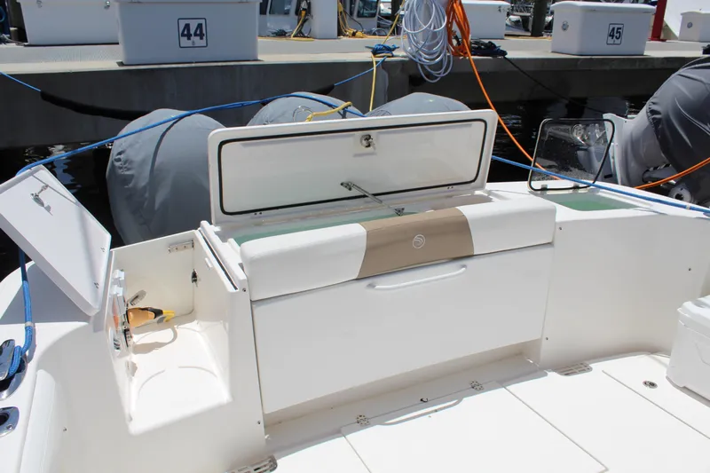  Yacht Photos Pics 2016 Edgewater 370CC boat interior with storage compartments and dock in background.