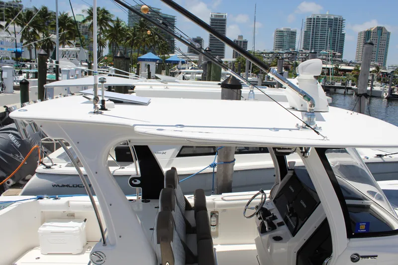  Yacht Photos Pics 2016 Edgewater 370CC boat docked at marina with city skyline in background.