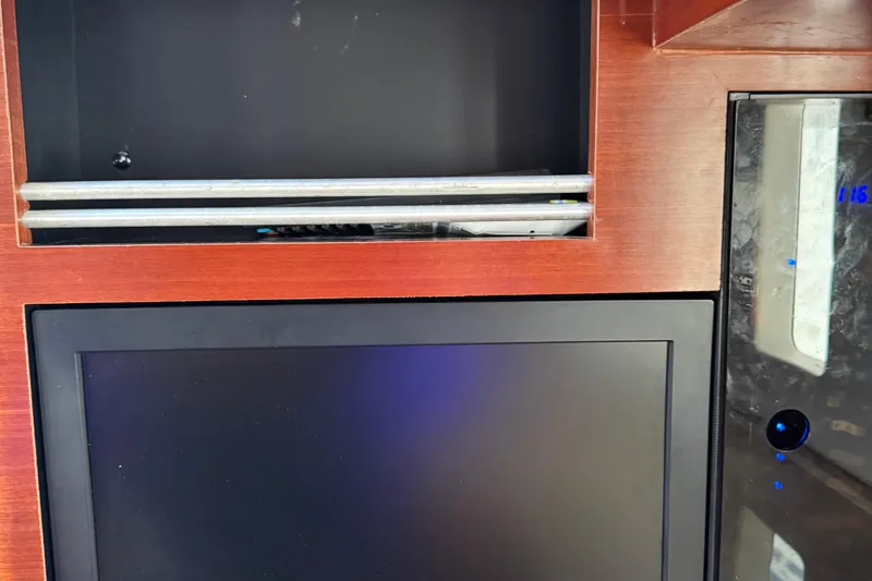  Yacht Photos Pics Interior of 2016 Edgewater 370CC boat with wooden paneling and electronic display.