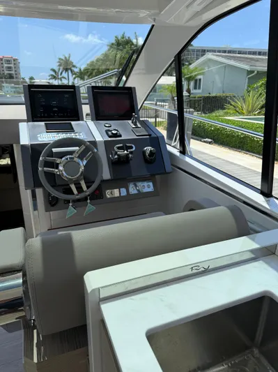  Yacht Photos Pics 2023 Rio Yachts SPORT COUPE helm with modern controls and steering wheel.