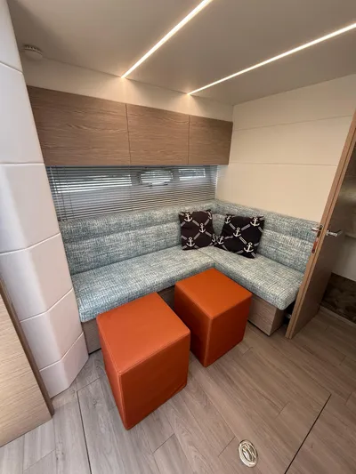  Yacht Photos Pics 2023 Rio Yachts SPORT COUPE interior with modern seating and nautical-themed cushions.