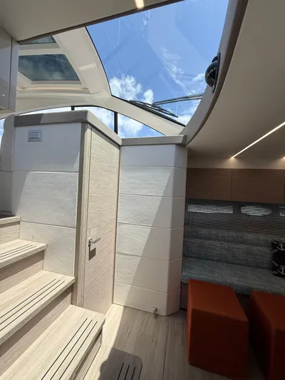  Yacht Photos Pics Interior of 2023 Rio Yachts SPORT COUPE with skylight and modern seating area.