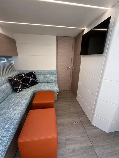  Yacht Photos Pics 2023 Rio Yachts SPORT COUPE interior with modern seating, TV, and nautical-themed decor.