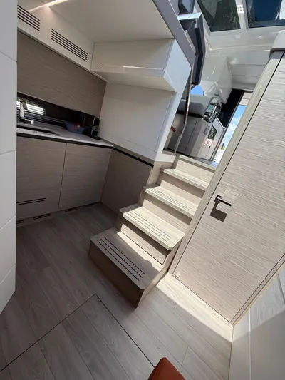  Yacht Photos Pics 2023 Rio Yachts SPORT COUPE interior with modern kitchen and wooden stairs.
