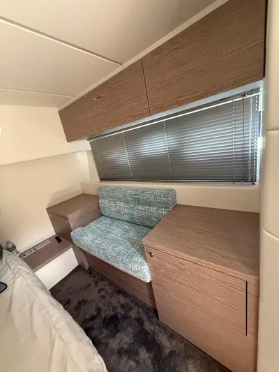  Yacht Photos Pics 2023 Rio Yachts SPORT COUPE interior with wooden cabinets and a cushioned seat.