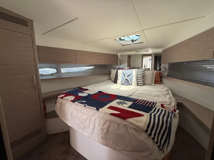  Yacht Photos Pics Luxurious bedroom interior of 2023 Rio Yachts SPORT COUPE with nautical-themed decor.