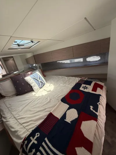  Yacht Photos Pics Luxurious bedroom interior of 2023 Rio Yachts SPORT COUPE with nautical-themed decor.