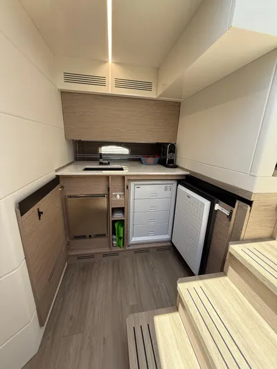  Yacht Photos Pics 2023 Rio Yachts SPORT COUPE interior kitchen with modern appliances and wooden cabinetry.