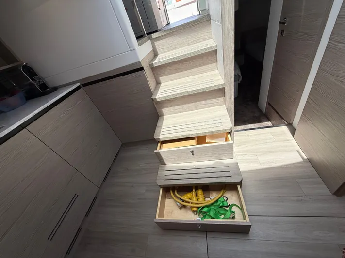  Yacht Photos Pics 2023 Rio Yachts SPORT COUPE interior with wooden stairs and storage drawers.