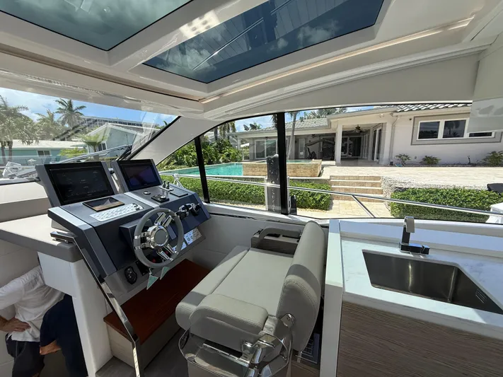  Yacht Photos Pics 2023 Rio Yachts SPORT COUPE helm with modern controls and luxurious interior.