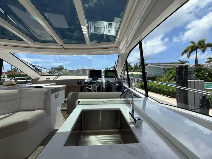  Yacht Photos Pics Interior of 2023 Rio Yachts SPORT COUPE with modern helm and luxurious seating.