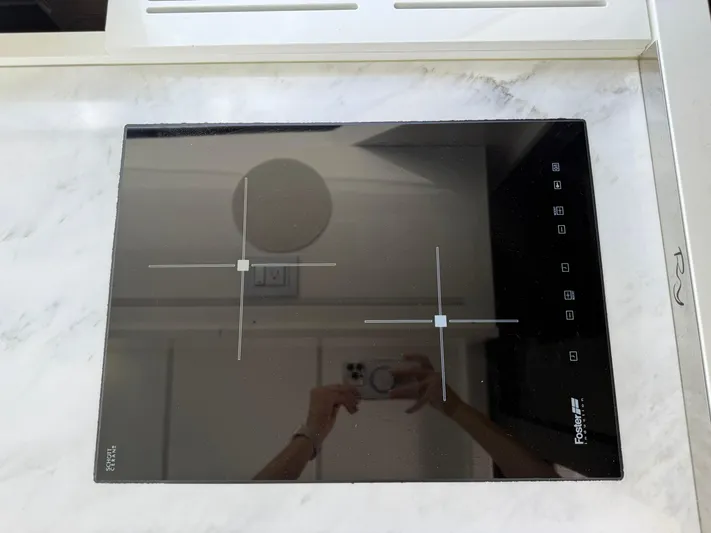  Yacht Photos Pics Modern induction cooktop on Rio Yachts SPORT COUPE 2023, featuring sleek design and touch controls.