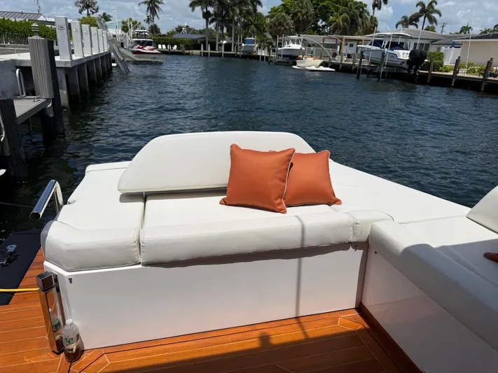  Yacht Photos Pics 2023 Rio Yachts SPORT COUPE with white seating and orange cushions by the water.