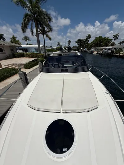  Yacht Photos Pics 2023 Rio Yachts SPORT COUPE docked, featuring sleek design and sunbathing area.