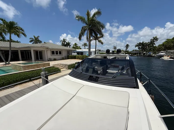  Yacht Photos Pics 2023 Rio Yachts SPORT COUPE docked near luxury waterfront home with palm trees.