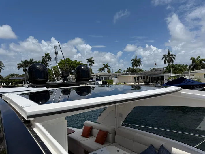  Yacht Photos Pics 2023 Rio Yachts SPORT COUPE with sleek design, docked under a clear blue sky.