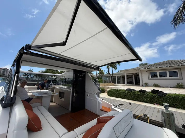  Yacht Photos Pics 2023 Rio Yachts SPORT COUPE with open canopy, docked near waterfront home.