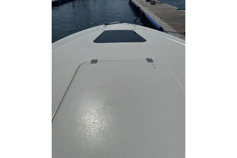  Yacht Photos Pics 2005 Intrepid 323 Cuddy boat deck near dock, sunny day.