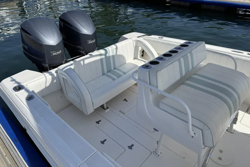  Yacht Photos Pics 2005 Intrepid 323 Cuddy boat with twin Yamaha 300 engines, docked on calm water.