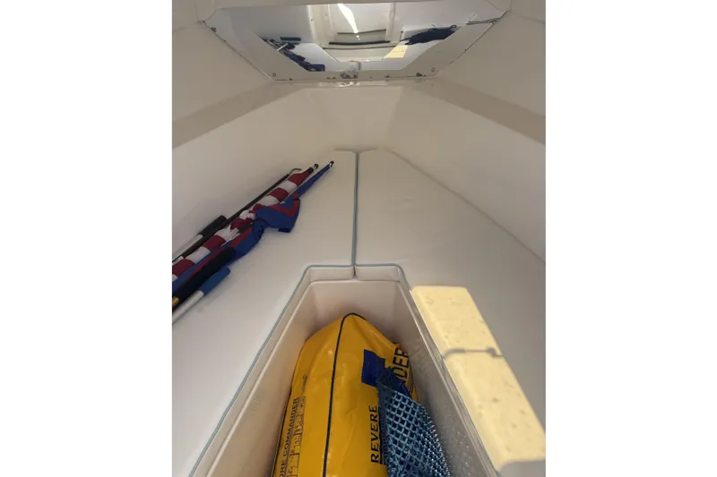  Yacht Photos Pics 2005 Intrepid 323 Cuddy cabin interior with safety equipment and storage.