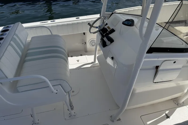  Yacht Photos Pics 2005 Intrepid 323 Cuddy boat interior with steering wheel and seating.