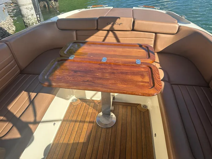  Yacht Photos Pics Interior of a 2015 Chris-Craft Launch 32 with wooden table.