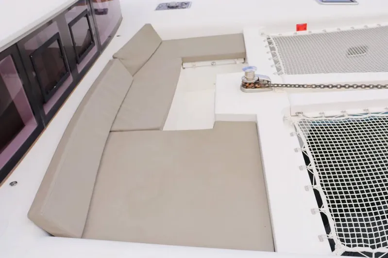 Libertas Ds Yacht Photos Pics Spacious seating area on 2019 Lagoon 450 F catamaran with beige cushions and netting.