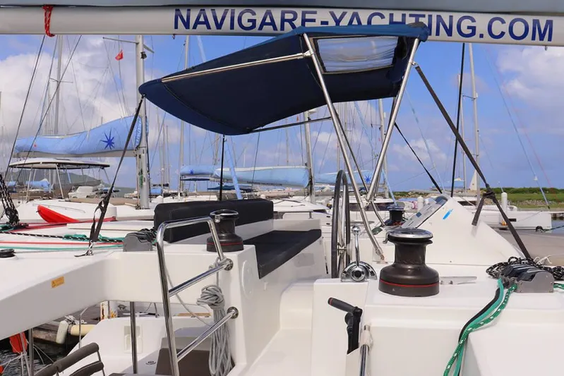 Libertas Ds Yacht Photos Pics 2019 Lagoon 450 F catamaran at dock, featuring navigational equipment and seating area.