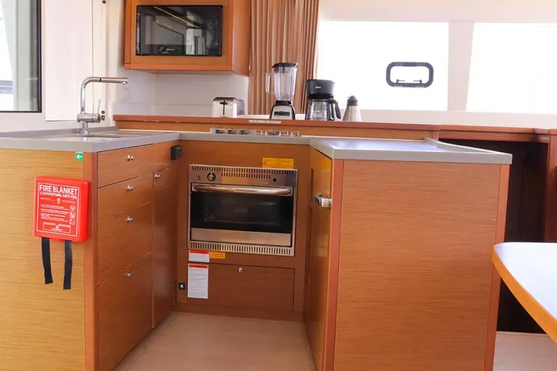 Libertas Ds Yacht Photos Pics 2019 Lagoon 450 F yacht kitchen with modern appliances and wooden cabinetry.