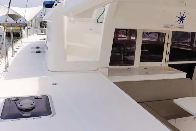 Libertas Ds Yacht Photos Pics 2019 Lagoon 450 F catamaran deck with seating and windows, docked at marina.