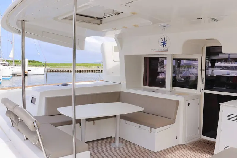 Libertas Ds Yacht Photos Pics 2019 Lagoon 450 F catamaran with outdoor seating and dining area, docked at marina.