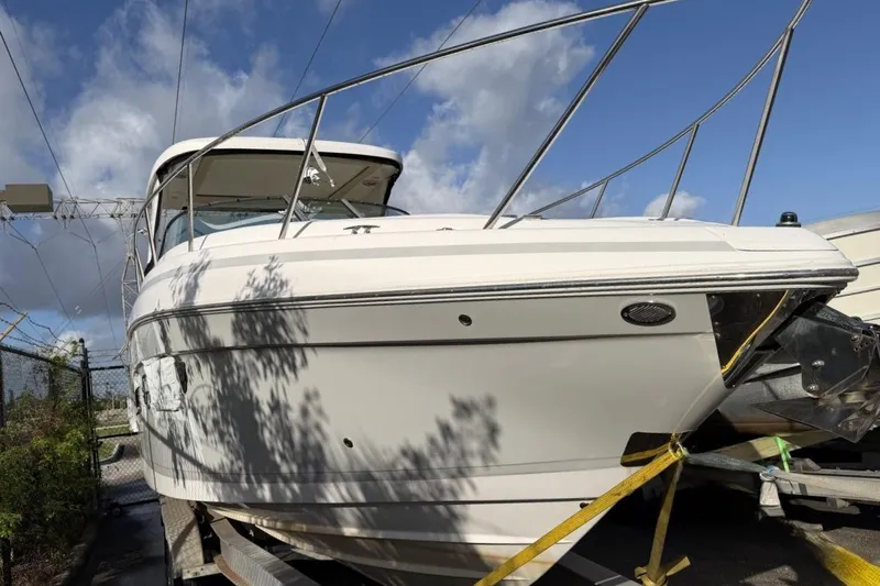  Yacht Photos Pics 2019 Regal 33 OBX boat on trailer under blue sky.