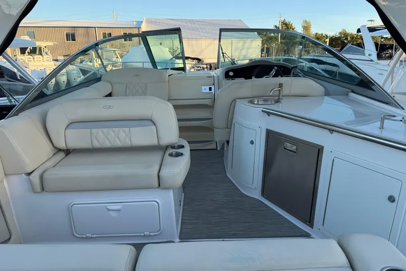  Yacht Photos Pics Interior of a 2019 Regal 33 OBX boat with seating and kitchenette.